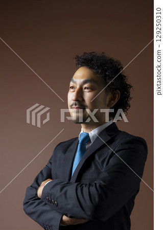 Bearded businessman in a suit Bearded businessman in a suit 129250310