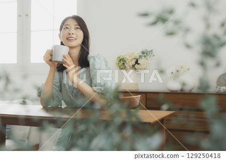 A woman drinking coffee A woman drinking coffee 129250418
