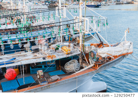 Traditional Fishing Boats Docked at Busan Harbor with Nets and Equipment 129250477