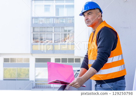 Engineer at work on construction site Engineer at work on construction site 129250798