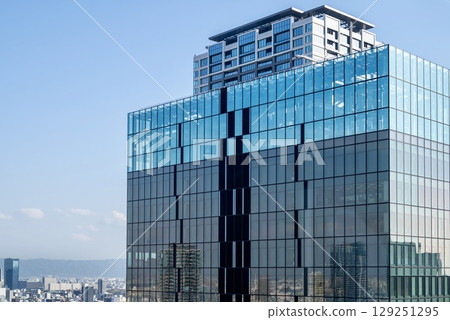 Urban landscape of glass-walled skyscrapers against the blue sky 129251295