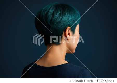 Woman with short teal hair facing away against dark background, showcasing modern hairstyle and fashion trend, AI Generative 129252884