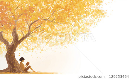 natural warm lighting, person reading a book under a large tree with golden leaves 129253464
