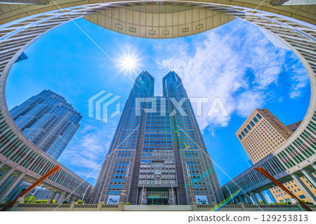 Tokyo cityscape, Japan, August 5th. Overlooking the Tokyo Metropolitan Government Building and office buildings... A ray of hope for a new era... Tokyo cityscape, Japan, August 5th. Overlooking the Tokyo Metropolitan Government Building and office buildings... A ray of hope for a new era... 129253813