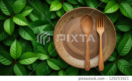 Fresh green natural background with wooden spoon, fork and plate. Natural textures concept 129253921