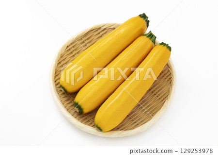 Yellow zucchini placed on a tray with a white background Yellow zucchini placed on a tray with a white background 129253978