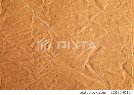brown paper with visible crumpled texture 129254011