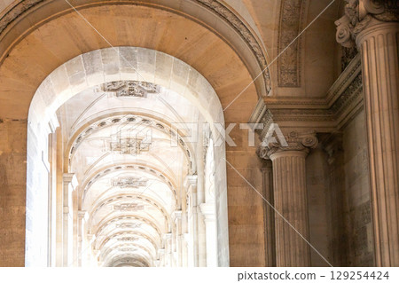 A long hallway features many arches and columns in a major building A long hallway features many arches and columns in a major building 129254424