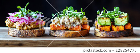 Three colorful breakfast sandwiches showcase fresh ingredients, banner Three colorful breakfast sandwiches showcase fresh ingredients, banner 129254773