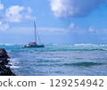 A relaxing yacht holiday scene on a clear tropical sea 129254942