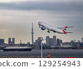 A moment in Tokyo Bay where the harbor scenery and the tracks of airplanes overlap 129254943