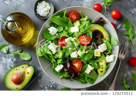 Fresh Avocado Salad Bowl with Mixed Greens and Cherry Tomatoes 129255012