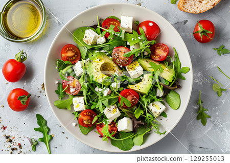Fresh Avocado Salad Bowl with Mixed Greens and Cherry Tomatoes 129255013