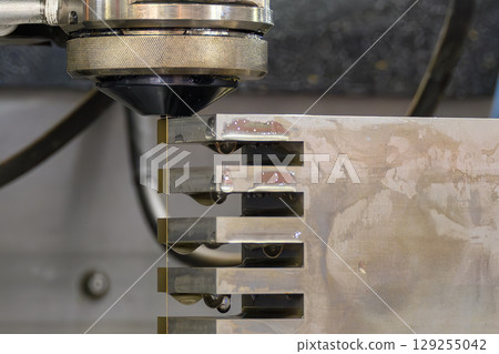 Closeup scene the operation of wire EDM machine control by CNC program. 129255042