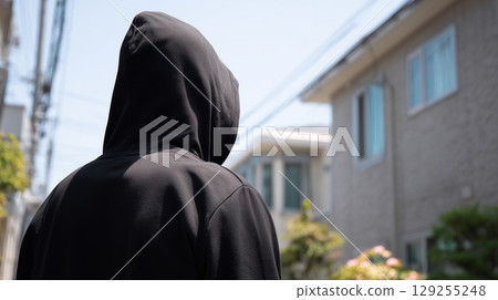 A suspicious person inspecting a house 129255248