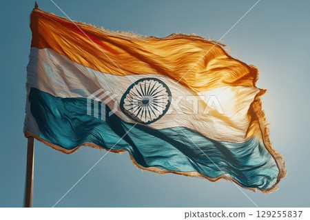 Indian flag waving boldly in sunlit blue sky background scene Indian flag waving boldly in sunlit blue sky background scene 129255837