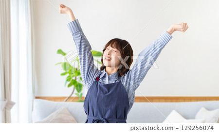 Woman relaxing with her arms stretched Woman relaxing with her arms stretched 129256074