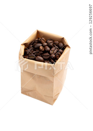 Fresh coffee beans overflowing from brown paper bag, aromatic arabica beans isolated on transparent background 129256697