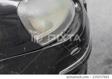 The front bumper on the right side of the black car is damaged in the form of chips, scratches, tears in plastic, paint. Insured accident event related to cars without danger to human life 129257665