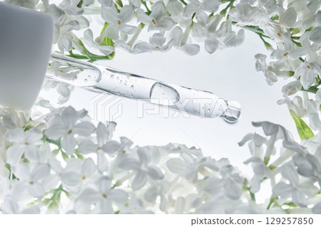 A serum pipette with white flowers. A serum pipette with white flowers. 129257850