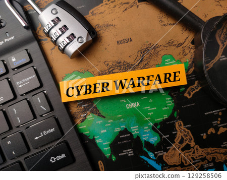 Black keyboard and padlock with the word CYBER WARFARE on a world map background. Geopolitical concept. Black keyboard and padlock with the word CYBER WARFARE on a world map background. Geopolitical concept. 129258506