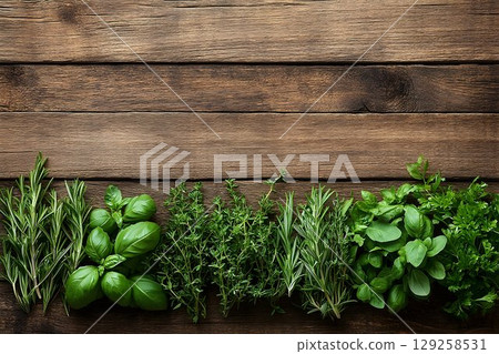 Fresh green herbs on rustic wooden background 129258531