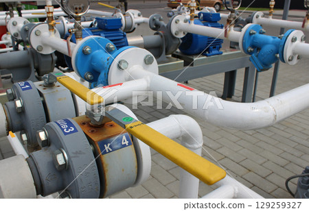 Shut-off valves and gas distribution pipes at a car gas station Shut-off valves and gas distribution pipes at a car gas station 129259327