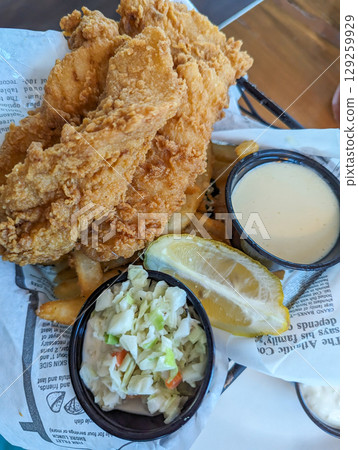 Traditional plate of fish and chips at restaurant Traditional plate of fish and chips at restaurant 129259929