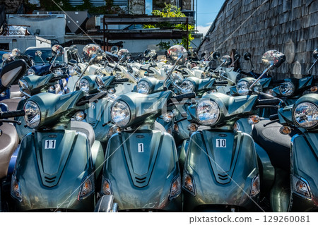 scooters on city street available for rent and ride scooters on city street available for rent and ride 129260081