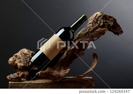 Bottle of red wine with empty label on a old snags. 129260347
