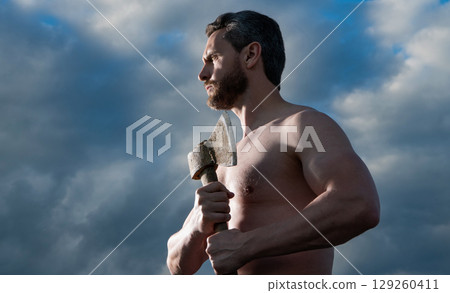 shirtless man with axe. craftsman man hold ax. brutal man on sky background 129260411