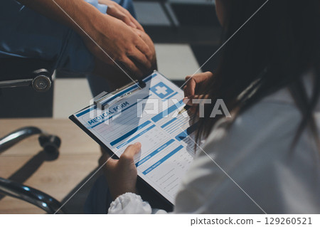 Physical therapist teaching a patient how to do exercises for his knee pain Physical therapist teaching a patient how to do exercises for his knee pain 129260521