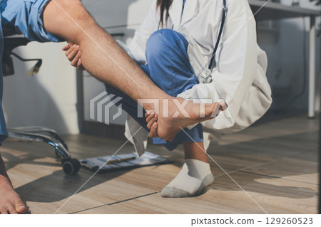 Physical therapist teaching a patient how to do exercises for his knee pain Physical therapist teaching a patient how to do exercises for his knee pain 129260523