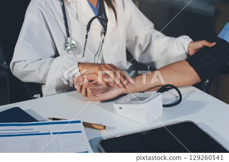 Doctor checking patient arterial blood pressure in hospital. Health care Concept 129260541