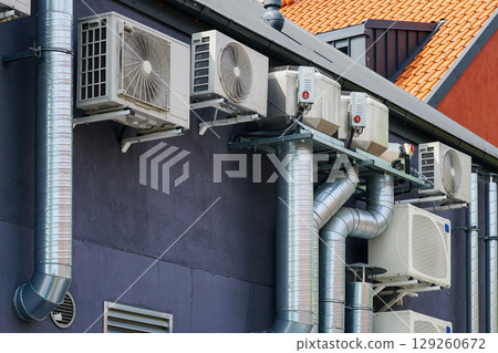 Modern HVAC Air Conditioning and Ventilation System Units Mounted on Building Exterior Wall 129260672