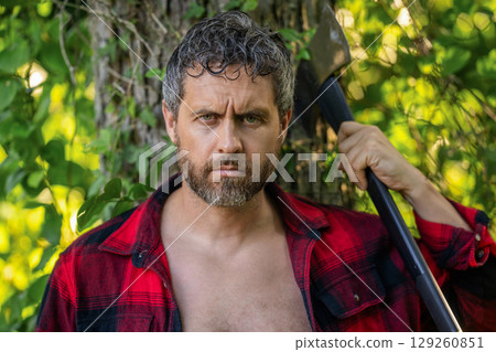 Brutal lumberjack. Brutality and masculinity. Hispanic lumberjack man with axe. Lumberjack axe. Man with logging axe. Brutal man in unbuttoned shirt. Lumberjack hardworking outdoor. Sharp tool 129260851