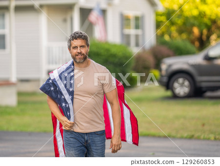 Independence day. American Flag for Independence Day or 4th of July. Man hold American flag outdoor. Patriotic man with patriotic symbol. American independence. National flag. Copy space 129260853