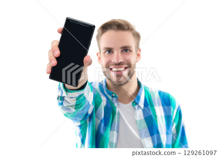 man showing phone screen on background, selective focus. photo of man presenting phone screen. 129261097