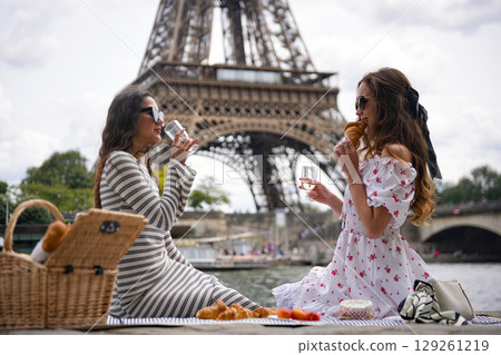 Girls Drinking Wine by Eiffel Tower  129261219
