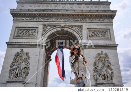 Woman with French flag at Arc de Triomphe Woman with French flag at Arc de Triomphe 129261249