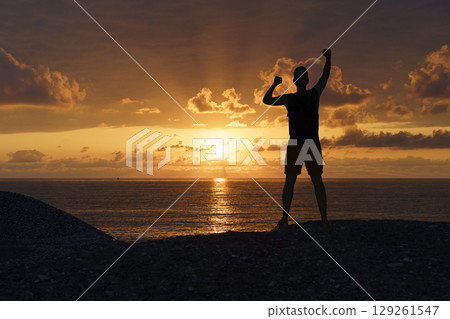 Victorious Silhouette at Sunset. Motivation and Achievement 129261547