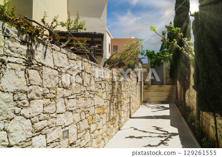 Explore a relaxing summer retreat in a green, serene setting with stone pathways 129261555