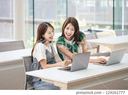 Female college student taking a lecture in the classroom Female college student taking a lecture in the classroom 129262777