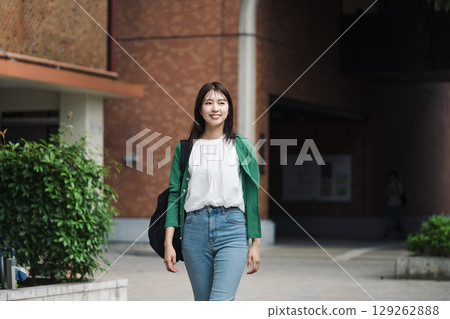 A female college student walking alone in school 129262888