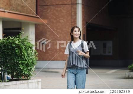 A female college student walking alone in school A female college student walking alone in school 129262889