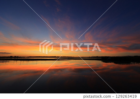 Morning glow reflected on the water surface Morning glow reflected on the water surface 129263419