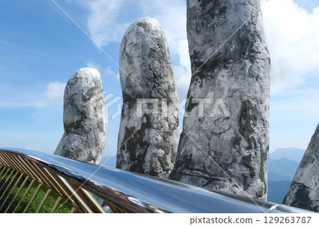 Da Nang, Vietnam Golden Bridge stone hand bridge and mountain view observatory at the Ba Na Hills Sunworld in DaNang Vietnam Da Nang, Vietnam Golden Bridge stone hand bridge and mountain view observatory at the Ba Na Hills Sunworld in DaNang Vietnam 129263787