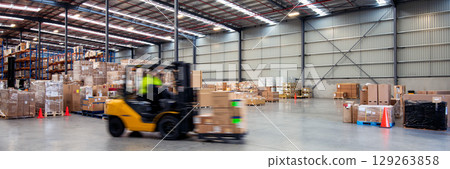 Forklifts running in a logistics warehouse Forklifts running in a logistics warehouse 129263858