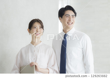Businessman and businesswoman with laptop Businessman and businesswoman with laptop 129263882