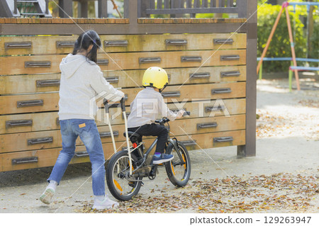 Children riding a bicycle 129263947